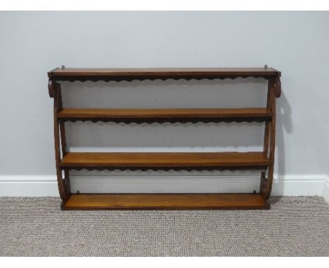 An Art Nouveau mahogany Wall hanging Shelf,&nbsp;with open shelves and dust covers 39in (99cm) wide x 26in (66cm) high. 