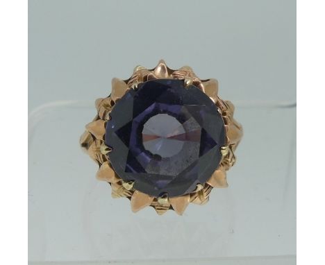 A synthetic colour change sapphire Dress Ring,&nbsp;the circular facetted stone in a textured rose gold mount, the inside of 