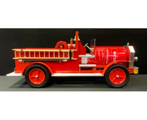 A scratch built bullet upcycled fire engine, made from an old fire extinguisher etc, rolling chasse, dials, 11cm long, 47cm h