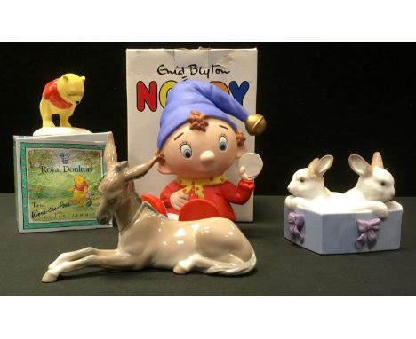 A Lladro donkey foal;  a Nao rabbits in a box;  a Noddy money bank;  a Royal Doulton Winnie the Pooh 