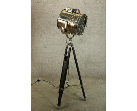 A vintage style floor standing lamp modelled in the form of a chrome plated theatre spot light raised on tripod base. Dia.32c