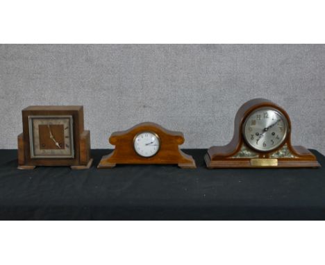 An Art Deco walnut veneered mantle square shaped mantle clock, the silvered dial with black Roman numerals raised on bracket 
