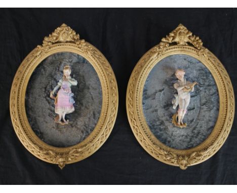 A pair of 20th century painted German porcelain figures, a man playing an instrument and a girl wearing a pink jacket, each m