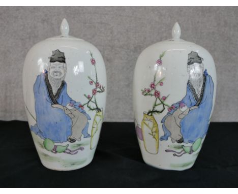 Two Japanese jars, decorated with a portrait of a man next to the branches of a cherry tree and Japanese text. Both jars show