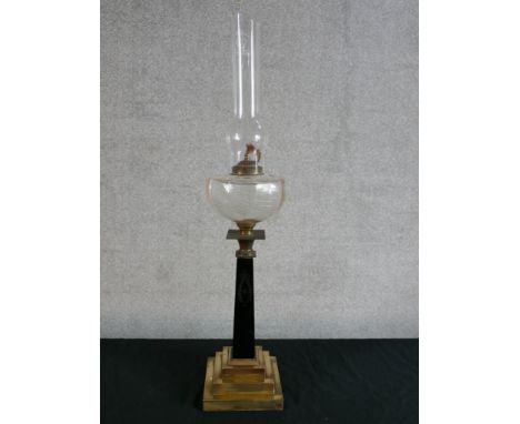A late 19th century oil lamp with tapering grey marble/hardstone column raised on stepped brass base. H.50cm. 