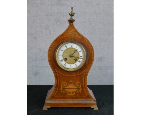 An Edwardian inlaid mahogany mantle clock, the enamelled dial with black Roman and Arabic numerals surmounted with brass urn 