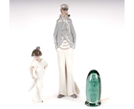 A Lladro figure of a sailor, modelled standing smoking a tobacco pipe, 37cms high; together with a Nao figure of a girl; and 