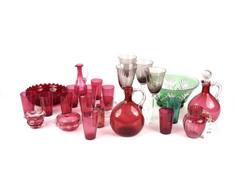 A collection of Victorian and later cranberry glass ware, including: two decanter bottles (one lacking stopper); a floral ena