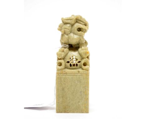 A Chinese soapstone seal, decorated with a mythical creature perched on a pierced sphere, stamped for "Collins" to the base, 