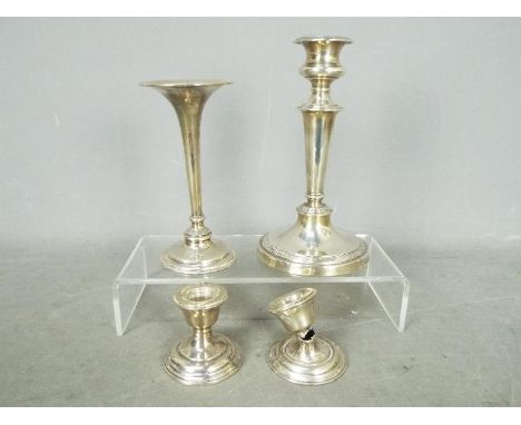 A silver hallmarked candlestick by Mappin and Webb, Sheffield assay 1912 18.5cm (h), a silver trumpet vase and two silver can