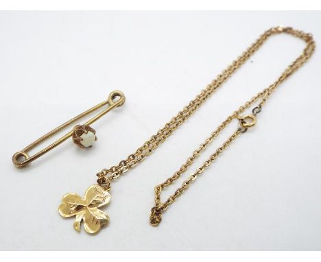 A 9ct yellow gold Shamrock pendant on yellow metal chain (presumed 9ct) and a yellow metal, opal set, bar brooch, approximate