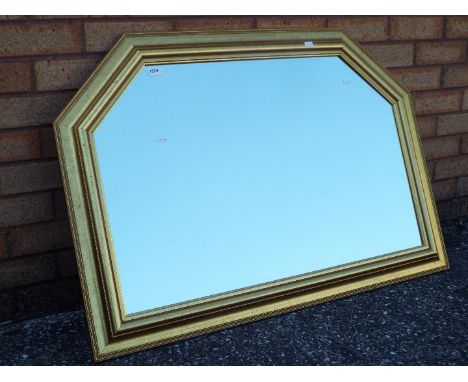 A gilt framed over mantel mirror measuring approximately 70 cm x 101 cm