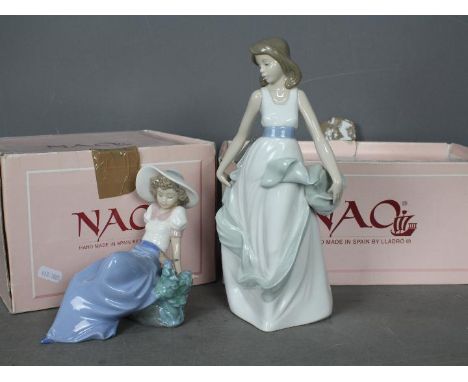 Nao - Two boxed figurines comprising Listening To Bird Song #1042 and Playing With The Wind # 1343, largest approximately 27 