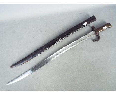 A french chassepot 1869 pattern sworn bayonet with brass handle dated 1869 and marked to the blade St Etienne. in a metal sca