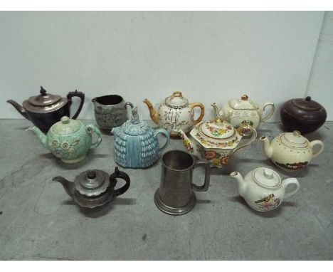 Tea Pot Collector - Left to right in rows description = Elkington art deco metal wood handle, Sadler ceramic / silver jug, un
