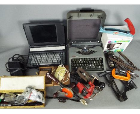A mixed lot to include vintage hand tools, boxed security light, portable typewriter, Sanyo word processor and similar.
