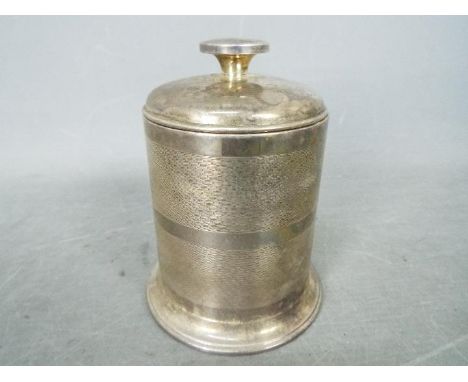 A George VI hallmarked silver cigarette box of cylindrical form, engine turned decoration to the body, Birmingham assay 1937,