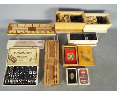 Lot to include vintage dominoes, playing cards, cribbage boards, chess pieces.