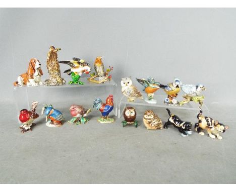 A collection of sixteen enamel / stone set trinket boxes, twelve containing necklaces with small pendants in the form of the 