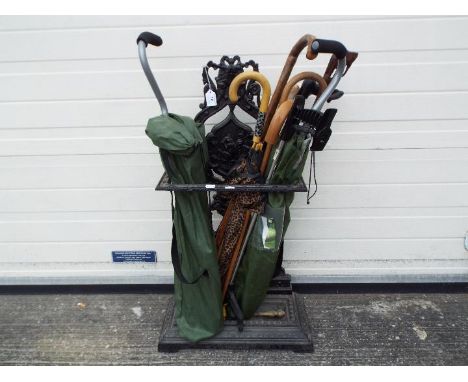 A cast iron, black painted stick / umbrella stand, with pierced decoration and central panel depicting a squirrel, approximat