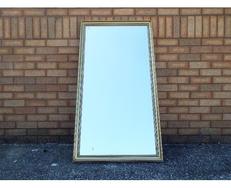 A gilt framed pier mirror measuring approximately 133 cm x 70 cm.