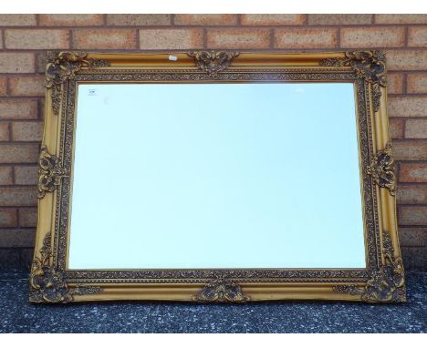 A large bevel edged mirror, approximately 80 cm x 110 cm.