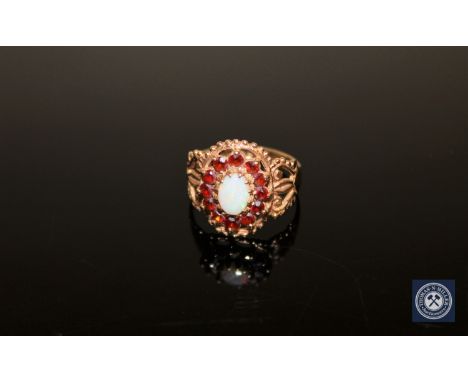 A 9ct gold garnet and opal cluster ring, size N/O CONDITION REPORT: 3.6g