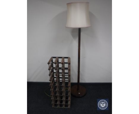 A mahogany standard lamp with shade and a wine rack 