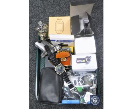 A tray containing digital cameras, mobile phones, table lighters, smart watch, digital video camera together with a silver CZ