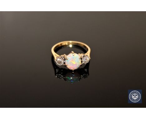 An 18ct gold opal and diamond three-stone ring, size M CONDITION REPORT: The ring is in good condition. It is stamped 18ct bu