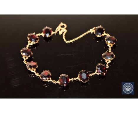 A 9ct gold garnet set bracelet CONDITION REPORT: 11.9g