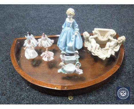 A D-shaped counter top display case together with a Royal Worcester figure, Grandmother's Dress 3081, small cherub wall shelf