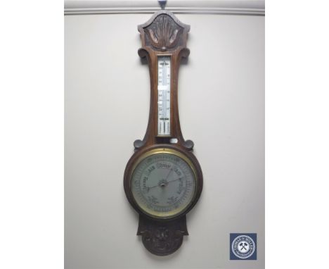 A carved oak cased banjo aneroid barometer with silvered dial 