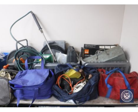Two crates and four holdalls of power tools, extension leads, hand tools etc and a hose pipe on reel 