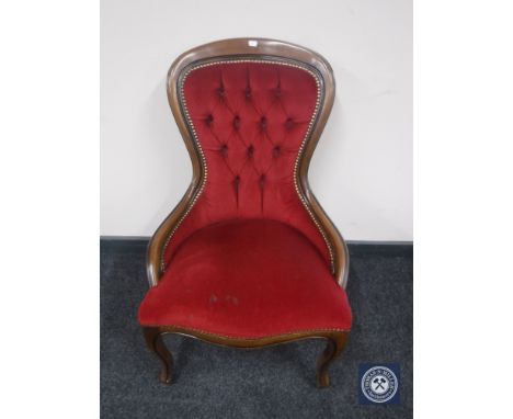 A reproduction lady's chair in red button dralon 