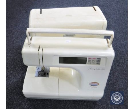 A Memory Craft 5000 cased electric sewing machine (lacking foot pedal), together with a light box