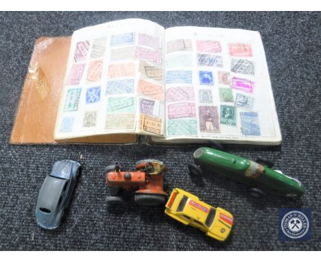 A mid 20th century city stamp album together with four die cast vehicles, Dinky Toys 301 tractor with driver, Triang Mimic to