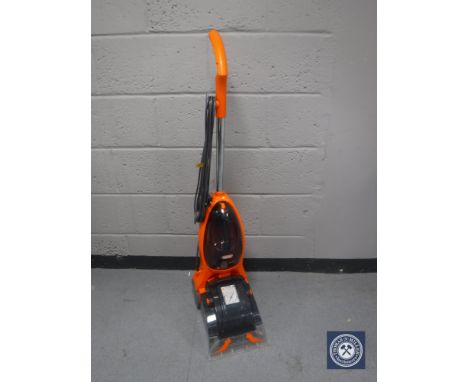 A carpet washer and a bundle of garden tools 