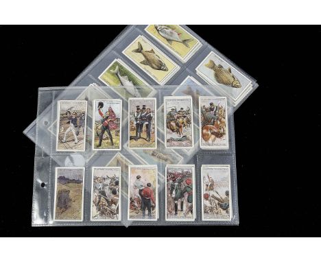 Cigarette Cards, Players,a modern album containing 11 sets to  include Victoria Cross, RAF Badges with Motto, Regimental Colo