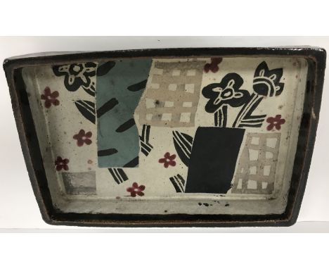 JOHN MALTBY (1936-2020) - a polychrome decorated studio pottery rectangular dish with stylised floral and lattice work decora