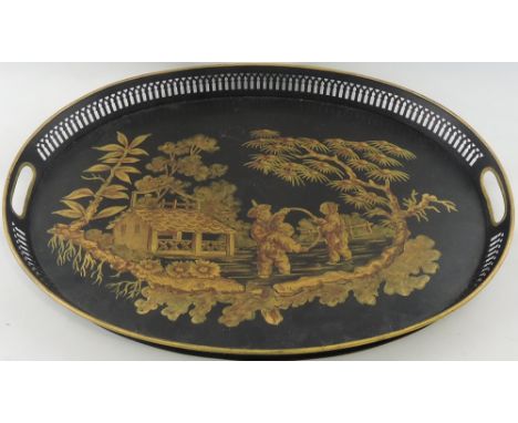 An attractive French metal tray of oval shape with a pierced gallery and a figural chinoiserie scene in gold colour of three 