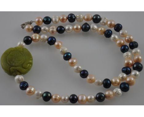 A grey-pink-white freshwater pearl necklace with a green Korean jade carved centre. 