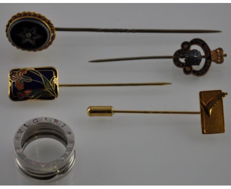 A Victorian yellow metal agate stick pin together with three further yellow metal enamel stick pins and a white metal band ma