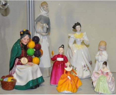 Six Royal Doulton porcelain figurines including Vanity, Bedtime and Balloon Seller, together with a Lladro porcelain figure o