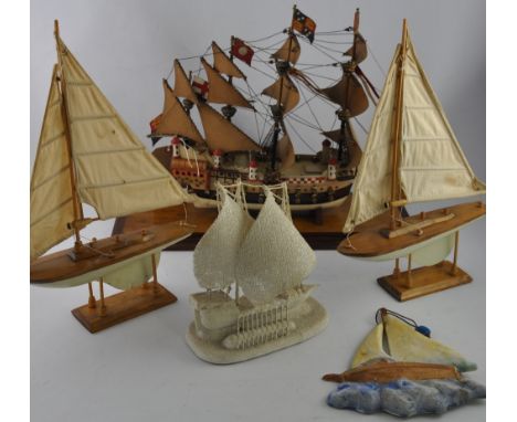 A collection of seven model galleons and yachts, a plaster wall plaque, together with a 1970s oil seascape and a print