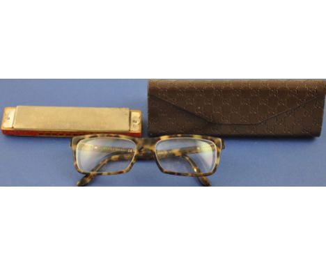 A pair of Gucci faux tortoishell spectacles together with a star harmonica 