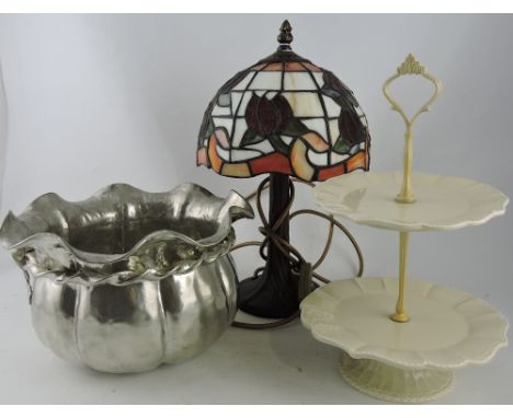 A Tiffany style stained glass table lamp, a plated jardiniere and a ceramic cake stand.