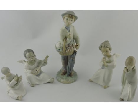 A Lladro porcelain figure of a Dutch boy flower seller, h:25cm, together with two Lladro porcelain musical angels, 1 other Ll