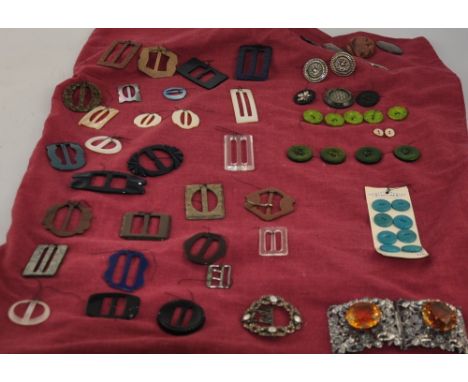 A pierced white metal belt buckle, set large faceted amber glass stones, a faux pearl and marcasite buckle, together with a c