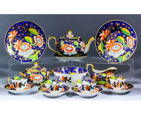 An early 19th Century English bone china part tea service decorated in an Imari palette, with scattered leaves and flowers (P